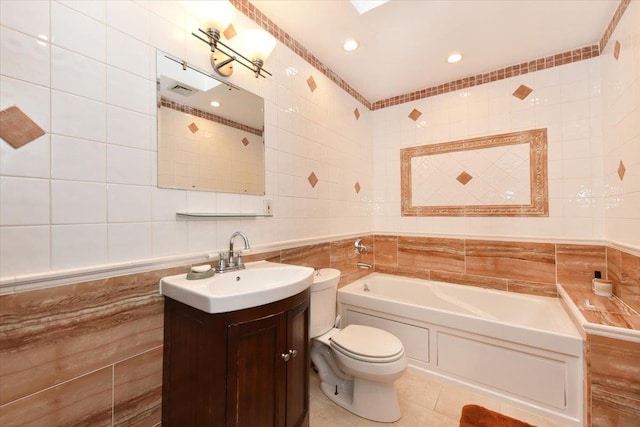 bathroom featuring tile patterned flooring, vanity, tile walls, a bathtub, and toilet