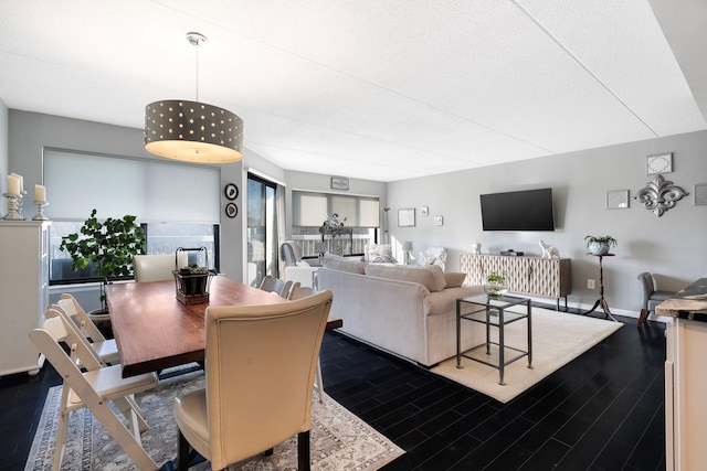 dining space with dark hardwood / wood-style flooring and plenty of natural light