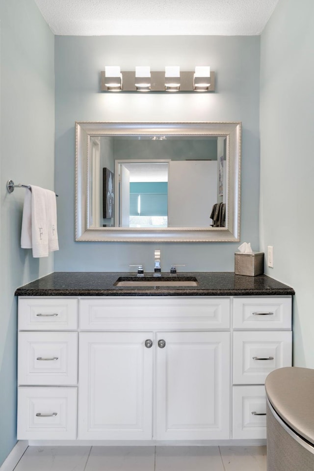 bathroom featuring vanity and a textured ceiling