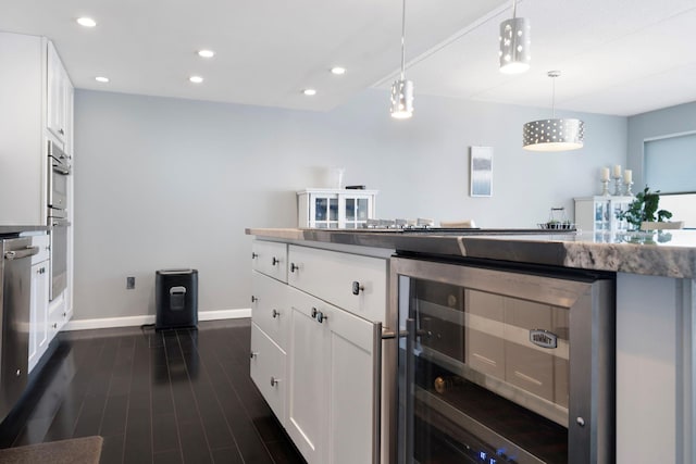 kitchen featuring white cabinets, dark wood-type flooring, beverage cooler, and decorative light fixtures