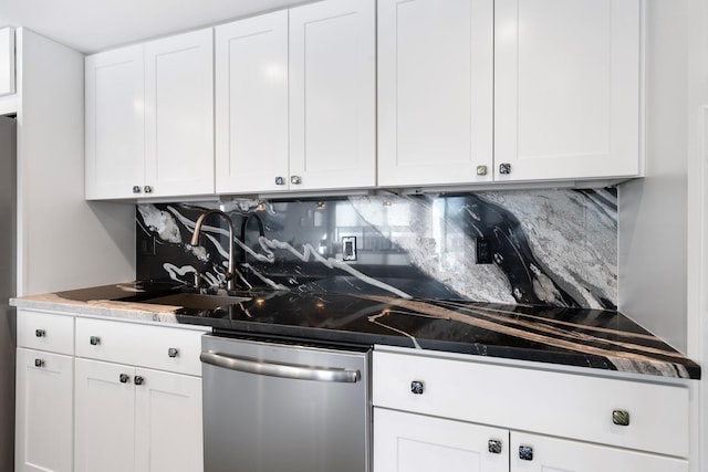 kitchen featuring tasteful backsplash, white cabinets, sink, and dishwasher