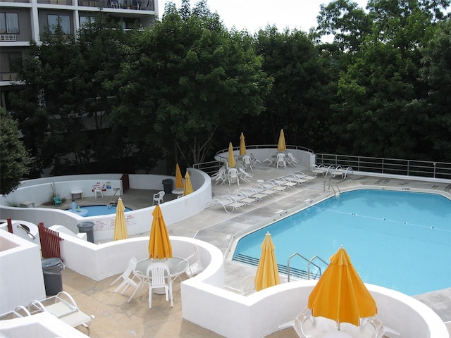 view of pool featuring a patio and an outdoor fire pit