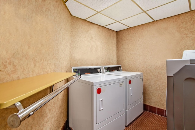 laundry area with tile patterned floors and washing machine and clothes dryer