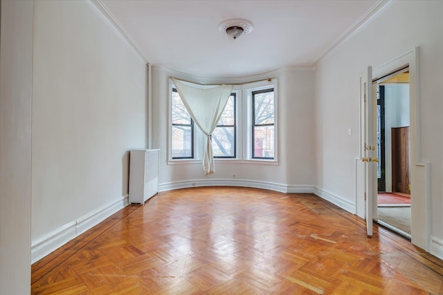 spare room featuring crown molding, light parquet flooring, and radiator heating unit