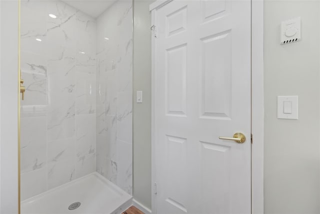 bathroom with a tile shower