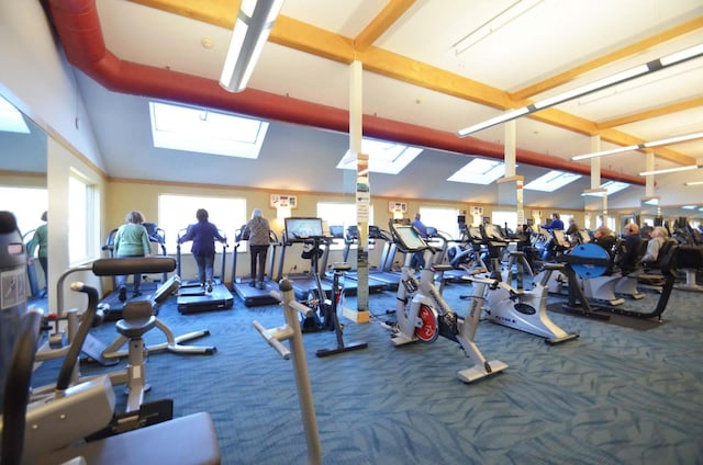 gym with carpet, plenty of natural light, and lofted ceiling