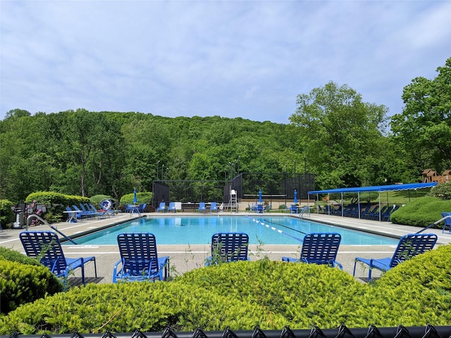 pool featuring a patio and fence