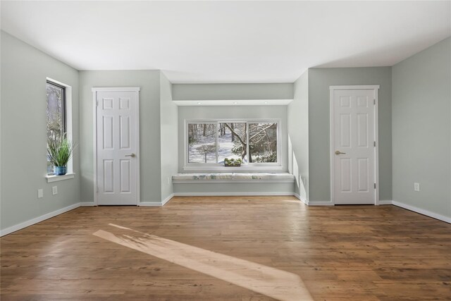 interior space with baseboards and wood finished floors