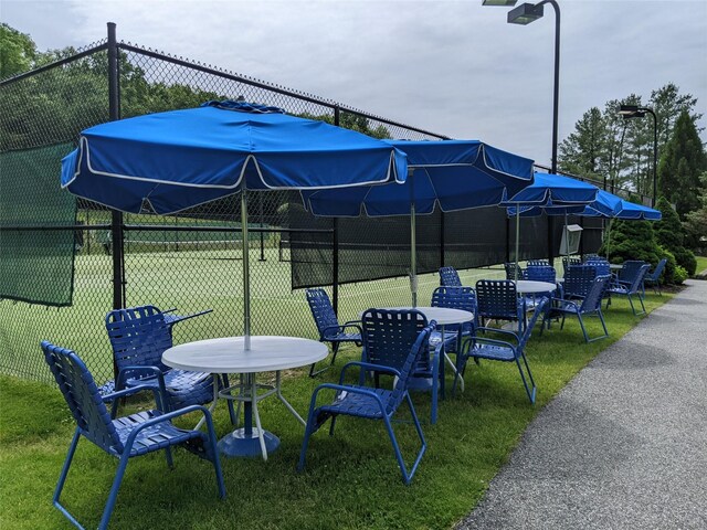 view of yard featuring fence and outdoor dining area