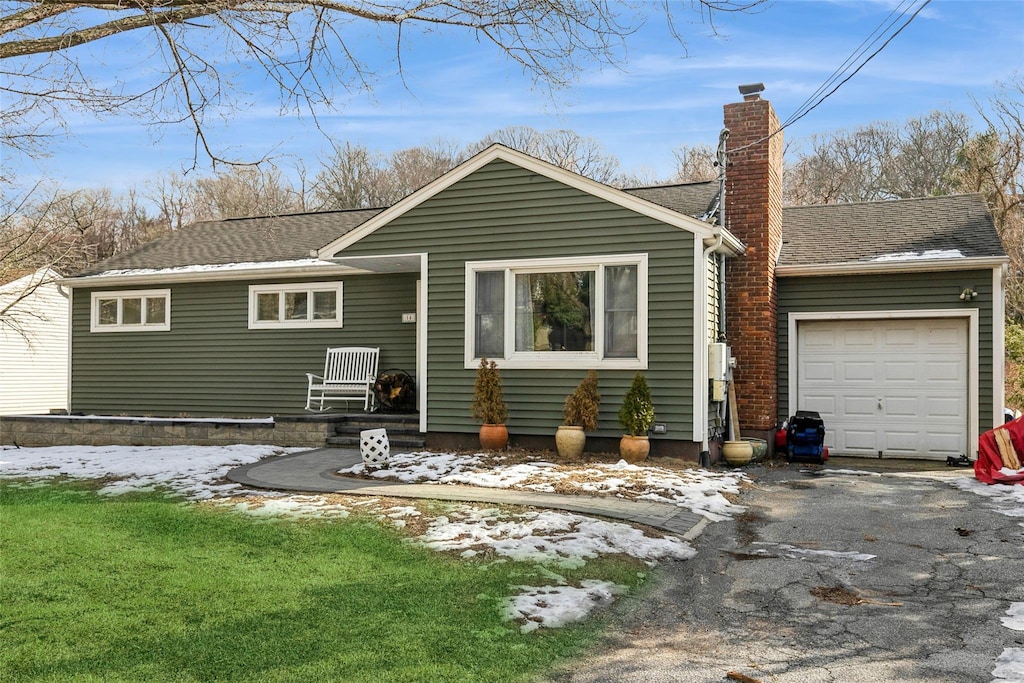 snow covered property with a garage