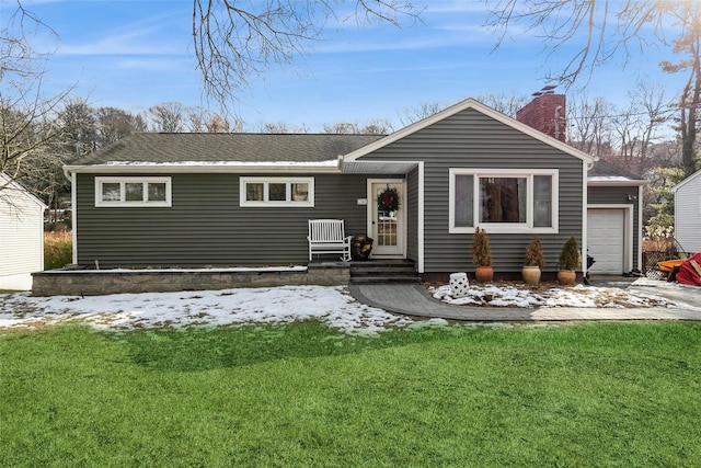 ranch-style home with a garage and a lawn