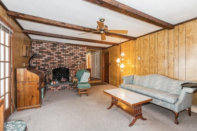 carpeted living room with a fireplace, beamed ceiling, and wood walls