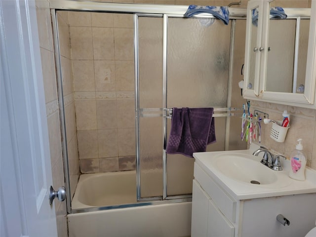 bathroom with bath / shower combo with glass door and vanity