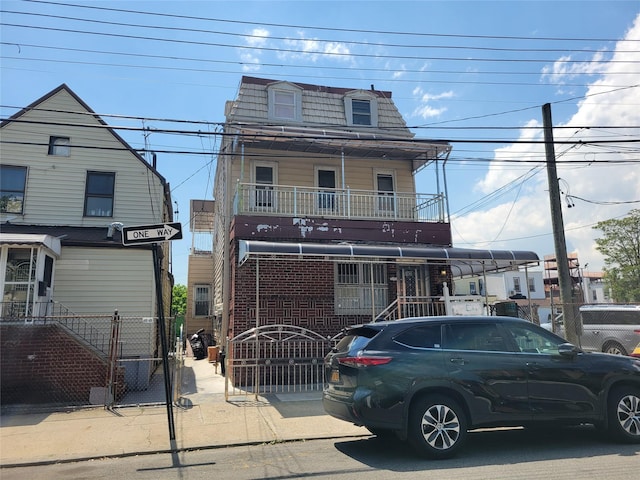 45-24 Burling St, Flushing, NY 11355 - view of front of house with mansard roof, a gate, and fence