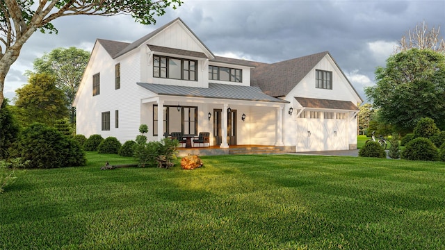 modern farmhouse featuring metal roof, covered porch, roof with shingles, a front lawn, and a standing seam roof