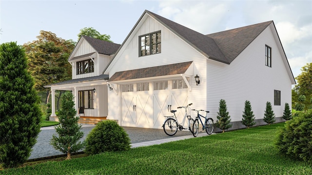 view of side of home with a garage, a shingled roof, board and batten siding, and a yard