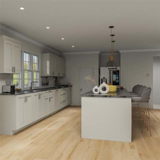 kitchen with pendant lighting, dark countertops, and a center island