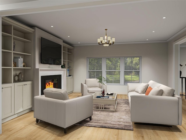 living room featuring ornamental molding, light wood-type flooring, a chandelier, and a glass covered fireplace