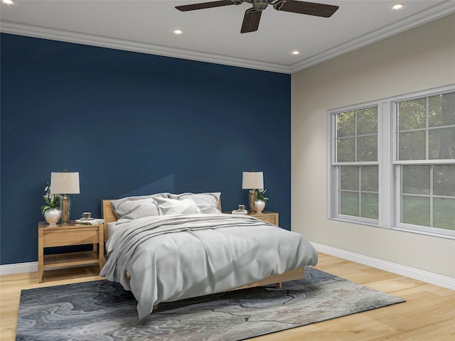 bedroom with baseboards, crown molding, and wood finished floors