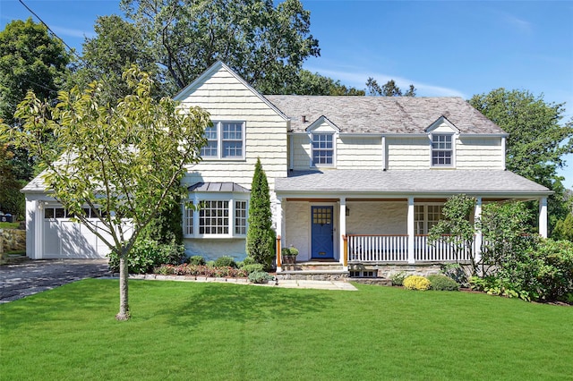 view of front of house featuring a porch, a shingled roof, driveway, and a front lawn