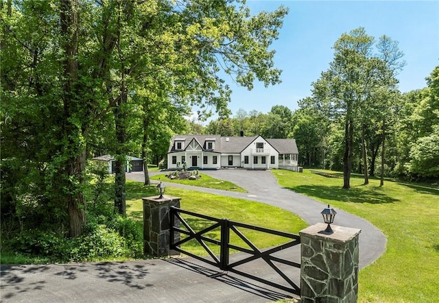 view of gate with a lawn