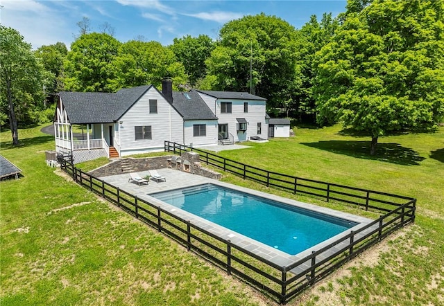 view of pool featuring a yard, an outdoor structure, and a patio area