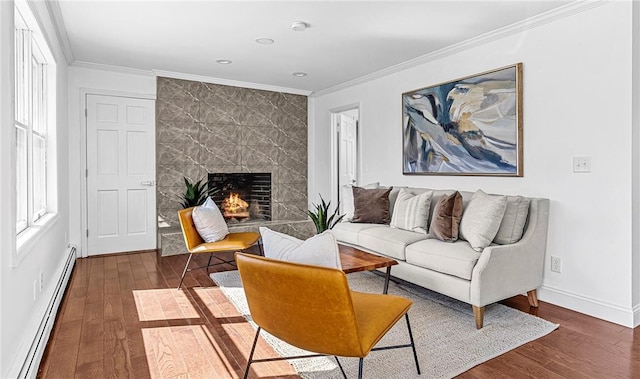 living room with dark hardwood / wood-style flooring, crown molding, a fireplace, and baseboard heating