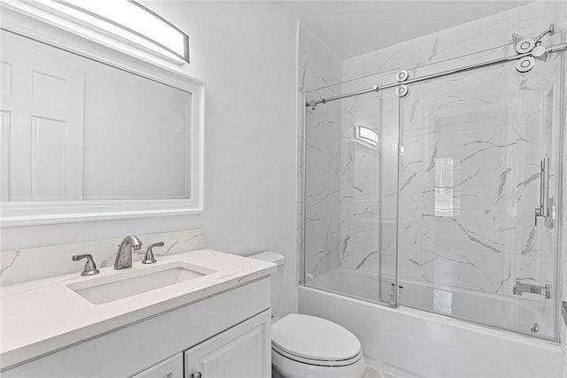 full bathroom featuring vanity, combined bath / shower with glass door, and toilet