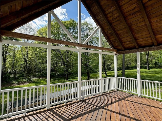 unfurnished sunroom featuring lofted ceiling with beams and wood ceiling