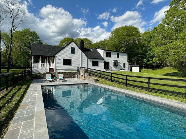 view of swimming pool with a patio and a lawn