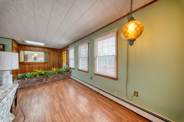 unfurnished sunroom featuring a baseboard heating unit