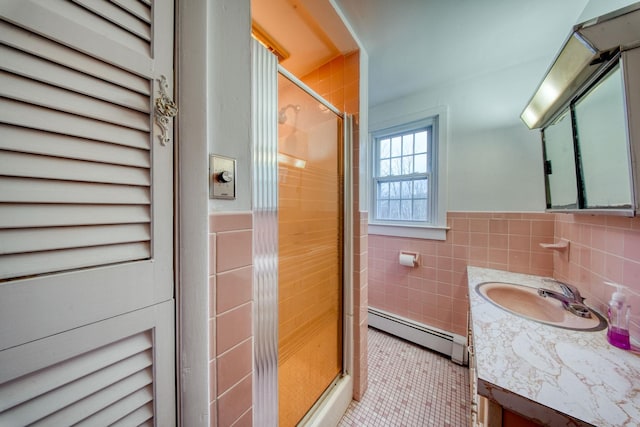 bathroom with walk in shower, tile walls, baseboard heating, and tile patterned flooring