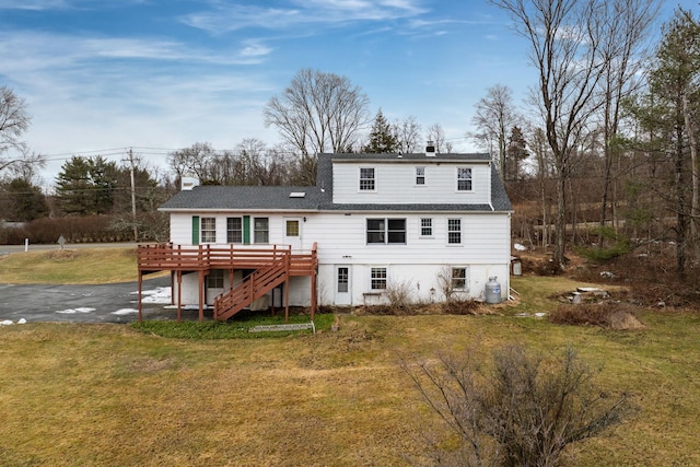 back of house with a yard and a deck