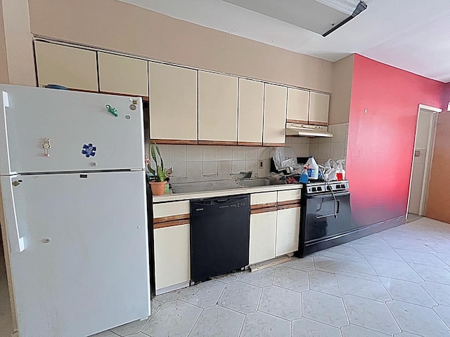 kitchen with black appliances and decorative backsplash