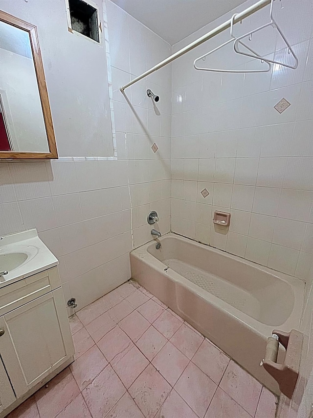 bathroom featuring tile walls, tile patterned floors, vanity, and tiled shower / bath