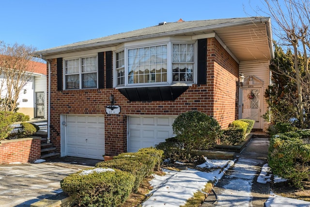 view of front of home with a garage, driveway, and brick siding