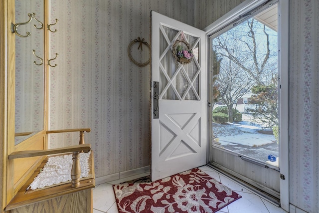 entryway featuring a healthy amount of sunlight, wallpapered walls, and baseboards