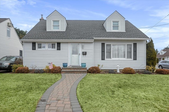 cape cod house featuring a front lawn