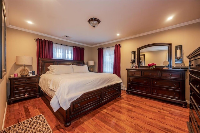 bedroom featuring hardwood / wood-style floors and ornamental molding