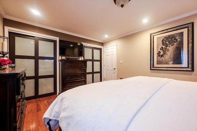 bedroom featuring dark hardwood / wood-style flooring and crown molding