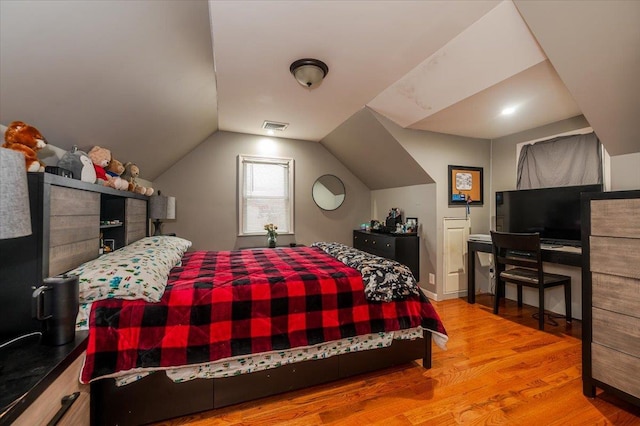 bedroom featuring wood-type flooring and lofted ceiling