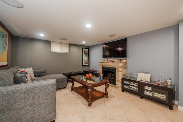 living room with light tile patterned floors and a fireplace