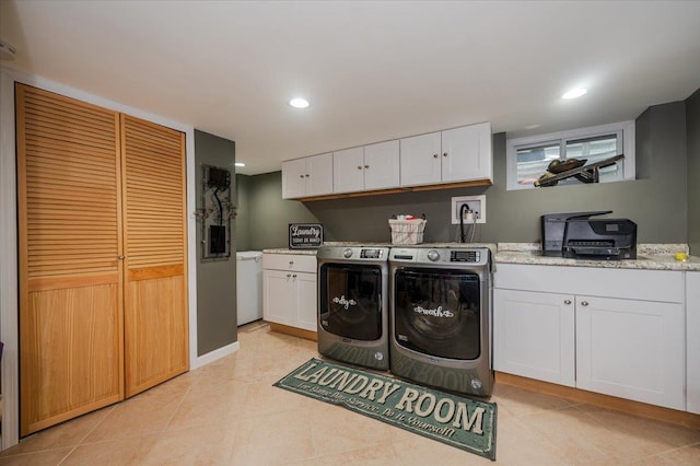 washroom featuring light tile patterned floors and washing machine and clothes dryer