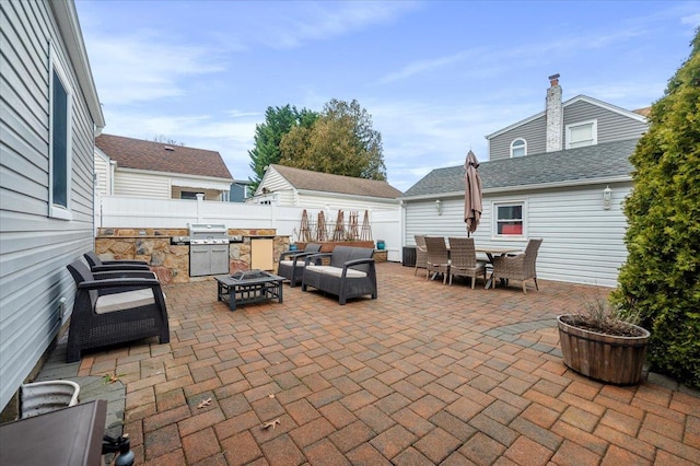 view of patio featuring a grill and an outdoor living space with a fire pit