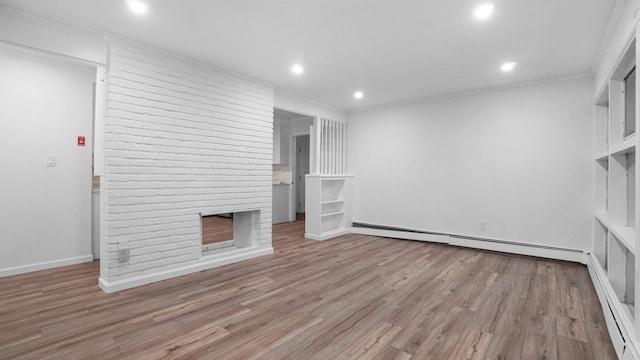 unfurnished living room with a baseboard radiator, recessed lighting, ornamental molding, a brick fireplace, and wood finished floors