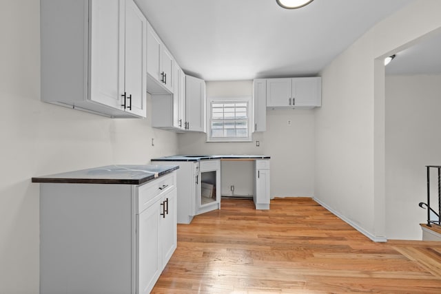 kitchen with light hardwood / wood-style floors and white cabinets