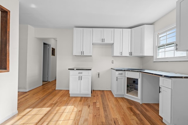 kitchen featuring white cabinetry and light hardwood / wood-style floors