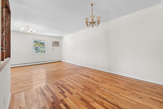 empty room with a baseboard radiator, light hardwood / wood-style flooring, and a notable chandelier