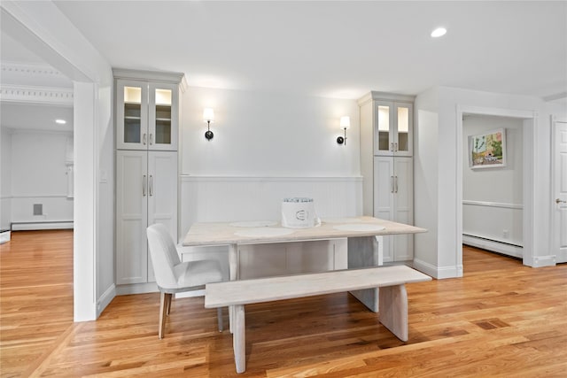 dining room with light hardwood / wood-style floors, a baseboard radiator, and breakfast area