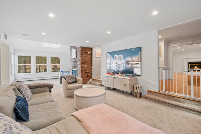 carpeted living room featuring baseboard heating, a skylight, and a fireplace